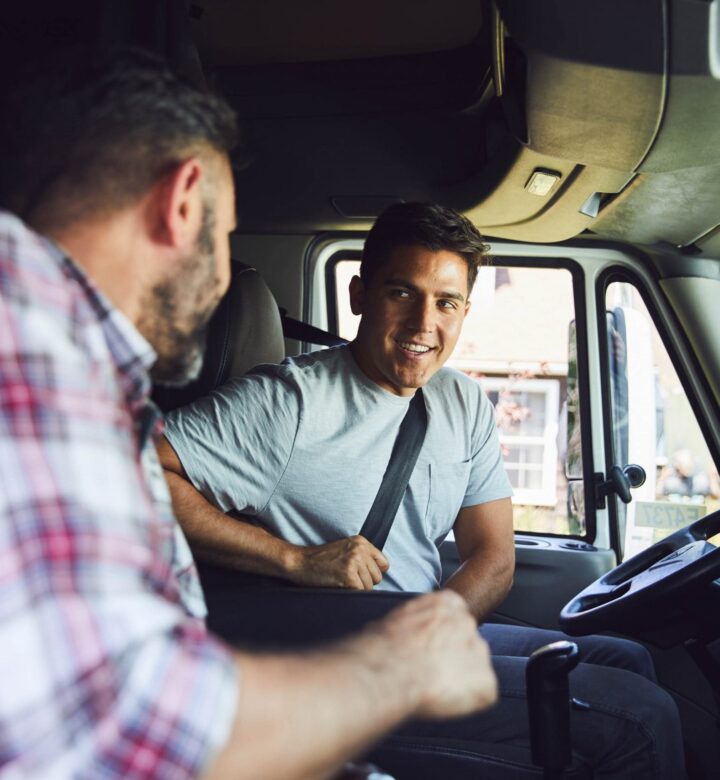 two men talking in truck