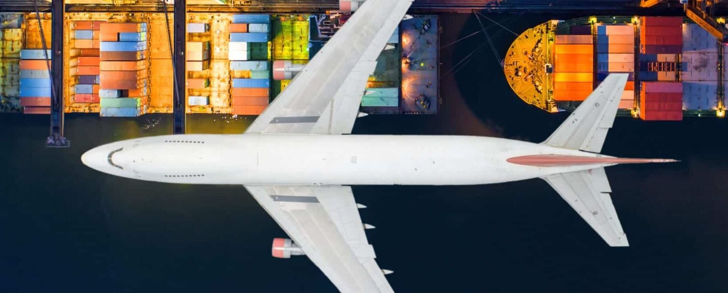 Airplane flying over ocean port