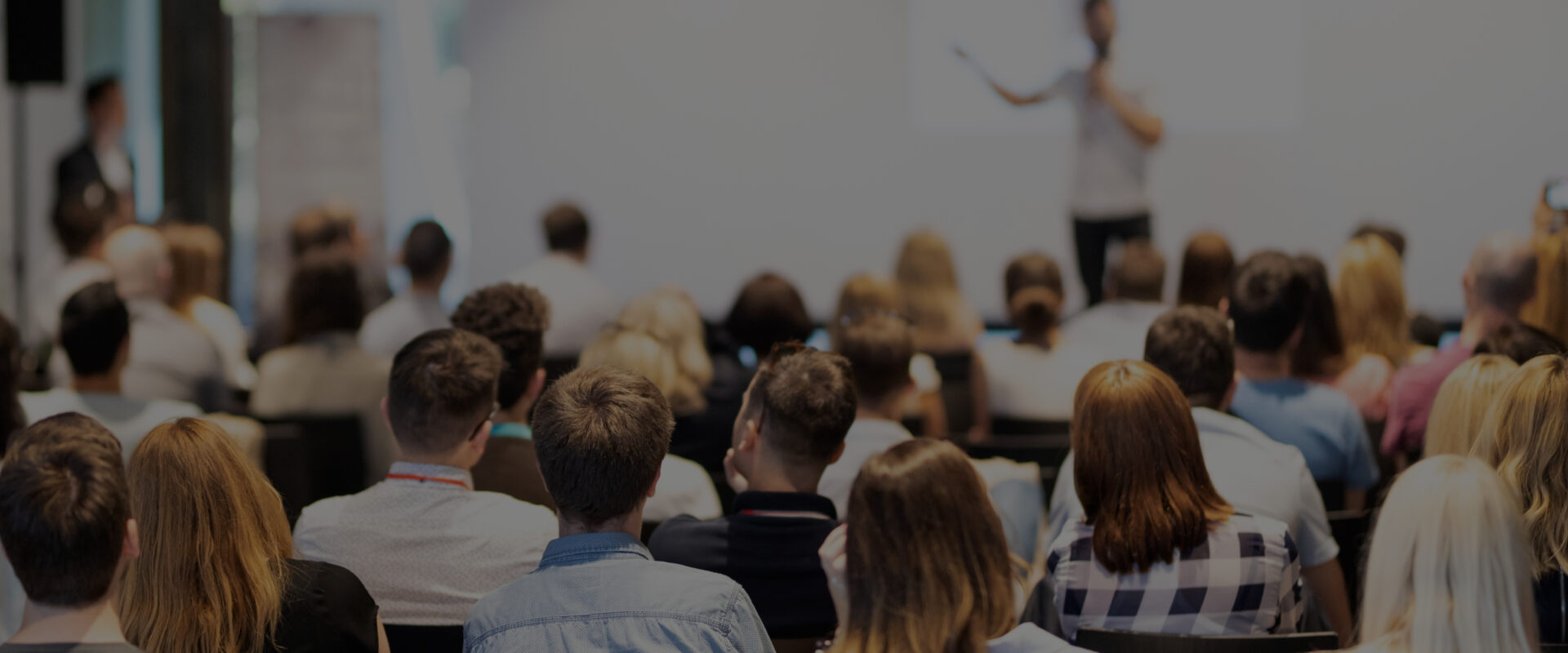 people listening to a speaker