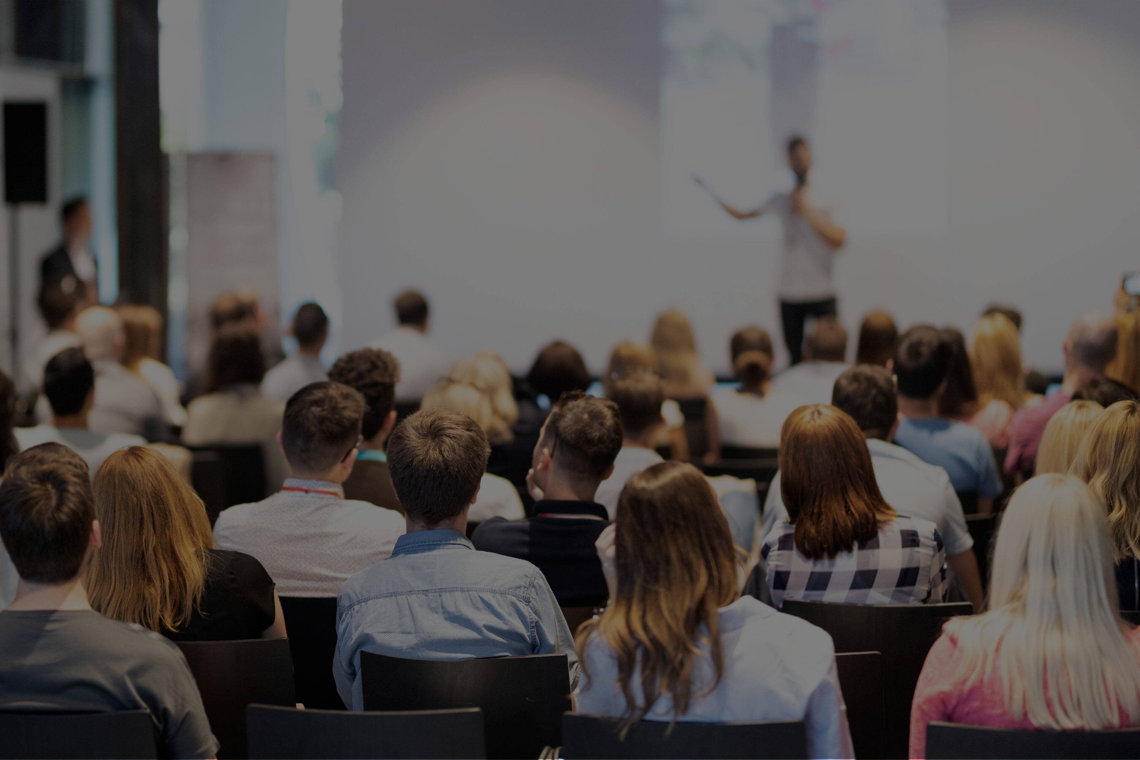 people listening to a speaker